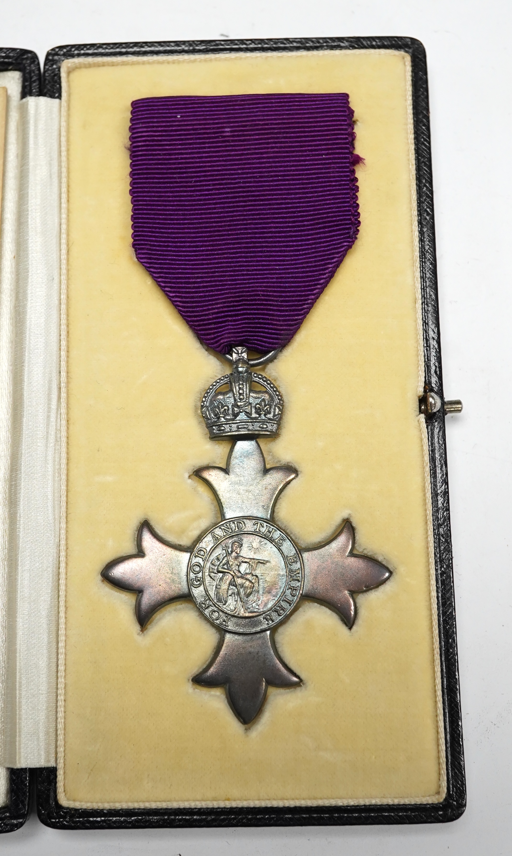 Order of the British Empire civil M.B.E. With first type purple ribbon, George V sterling silver by Garrards, hallmark for 1919, cased with instruction leaflet for wearing the insignia. Condition - good.